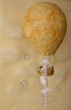 a paper hot air balloon with writing on it and a ladder attached to the bottom