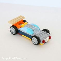 a toy car made out of legos on a white surface