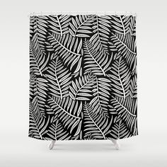 a shower curtain with black and white leaves printed on the front, in an abstract manner