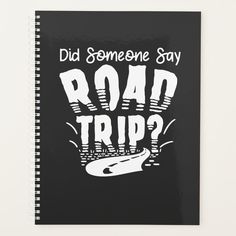 a spiral notebook with the words road trip written in white on black paper, which reads did someone say road trip?