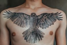 a man with a bird tattoo on his chest