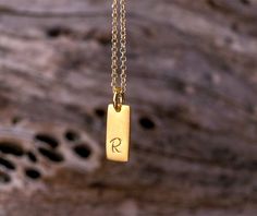 Set of 2 smooth 14k solid gold initials on one necklace. Rectangular tiny tags available in 14k solid yellow, white or 18k rose gold and can be bought mixed as well. The tag is stamped by hand. You can choose the charms with a 14k solid gold dainty chain or without a chain. You can choose between a charm with an initial, symbol, number or a blank charm. Please note your font (last picture) and letter choices in the note to seller box at check out. The pendant is 13mm long and 5mm wide. You can c Minimalist 14k Gold Hand Stamped Charm Necklace, Minimalist Hand Stamped Initial Necklace, Minimalist Yellow Gold Initial Necklace For Personalized Gift, Minimalist Yellow Gold Hand Stamped Charm Necklace, Classic Yellow Gold Hand Stamped Jewelry, Minimalist Hand Stamped Initial Necklace For Anniversary, Classic Hand Stamped Yellow Gold Jewelry, Gold Charm Necklace With Engraving Option, Gold Charm Necklaces With Engraving Option For Everyday