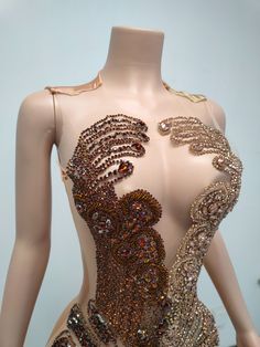 a mannequin is adorned with lots of beads and sequins on it's back