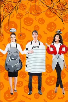 three people dressed up in halloween costumes with pumpkins hanging from the ceiling behind them