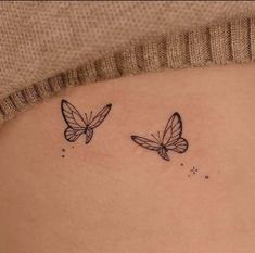 two butterflies on the back of a woman's stomach