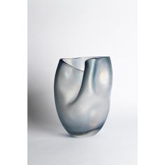 a glass vase sitting on top of a white table