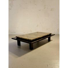 a wooden table sitting on top of a white floor