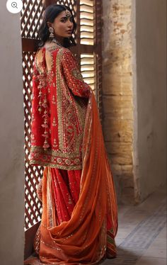 a woman in an orange and red outfit