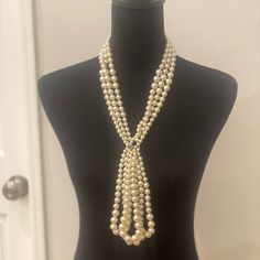 This Chanel Lavalier Necklace Is From The 2014 Autumn Pre-Fall, Metiers D’arts Collection. It Is Crafted With Several Strands Of White Faux Pearls And Champagne Gold-Toned Hardware. It Has A Lobster Clasp Closure That Hooks To An Adjustable Chain With A Dangling Cc Charm At The End. The Chain, Lobster Clasp And Cc Charm All Have A Textured Design. The Necklace Is Stamped On A Small Dangling Charm Near The Clasp: “Chanel B14 Cc A Made In Italy”. Can Be Adjusted By 3 Inches. Measurements: Length 25 In/ 63.5 Cm, Pendant Length: 6 In / 15.24 Cm This Is In Pristine Condition. Glamorous Pearl Necklace For Formal Occasions, Luxury White Pearl Necklace For Party, Elegant Cream Pearl Necklace For Formal Occasions, Glamorous White Pearl Necklace For Evening, Elegant Cream Jewelry For Evening, White Pearl Necklace For Evening, Elegant Cream Necklace For Formal Occasions, Elegant Lariat Pearl Necklace For Formal Occasions, White Lariat Pearl Necklace For Formal Occasions