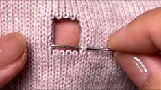 someone is stitching the stitches on a sweater