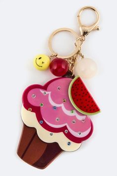 a keychain with an ice cream sundae on it and a smiley face