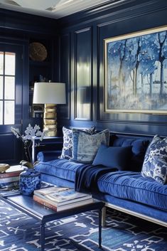 a living room with blue couches and paintings on the wall above them in shades of blue