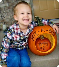 a young boy sitting on the steps with a pumpkin carved to look like a baby