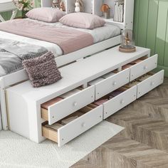 a white bed with drawers underneath it