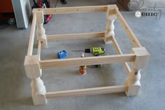 an unfinished bed frame with tools on the floor