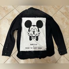 New With Tags - *For Adults, Inappropriate* This Black Denim Jacket Made By Black Island Definitely Has A Lot Of Character. For An Adult Who Likes A Bit Of Humor, The Back On The Jacket Has A Large Patch On The Back That Has A Photo Of Mickey Mouse Giving “The Bird” With His Two Hands And Also Below Has Text Saying “Black Island X Mickey “Da Fuckin” Mouse.” This Was Given As A Gag Gift Because Of My Love For Disney But I Don’t Have The Heart To Wear It. It’s A Really Nice, Stylish Denim Jacket W Distressed Black Outerwear For Streetwear, Black Denim Jacket With Patches For Fall, Black Distressed Outerwear For Streetwear, Casual Black Denim Jacket With Graphic Print, Black Denim Jacket With Graphic Print, Casual Black Denim Jacket With Patches, Cotton Mickey Mouse Long Sleeve Outerwear, Fall Mickey Mouse Cotton Outerwear, Casual Long Sleeve Mickey Mouse Outerwear