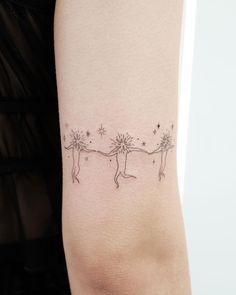 a woman's arm with two small stars on it