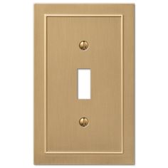 a light switch cover with two gold knobs