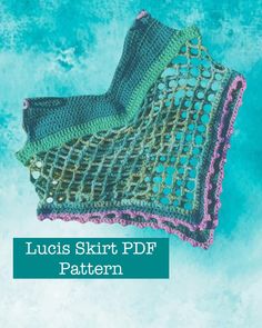 a crocheted blanket sitting on top of a blue surface with the words luous skirt