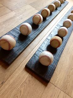 several baseballs are lined up on the floor