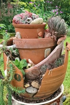 there are many potted plants in the planter on the stand and one is broken