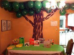 the table is set up for a children's birthday party with balloons and books