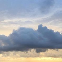 two airplanes are flying in the sky on a cloudy day with sun peeking through clouds