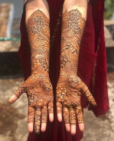 two hands with henna tattoos on them