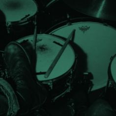 a pair of boots sitting on top of a drum set