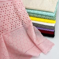 four different colors of lace on top of each other, one in pink and the other in white