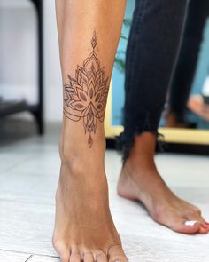 a woman's foot with a tattoo on it