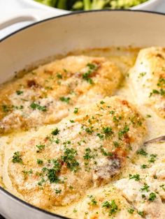 chicken parmesan in a skillet with broccoli on the side