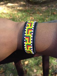 AfricanInspired Leather Beaded Bracelet by GlennandThem on Etsy African Beads Bracelets, Beaded African Bracelets, Ankara Bracelets, Jamaican Beaded Bracelet, Angolan Flag African Bracelets, Seed Bead Bracelet Patterns, African Beads, Beaded Bracelet Patterns, Bead Leather