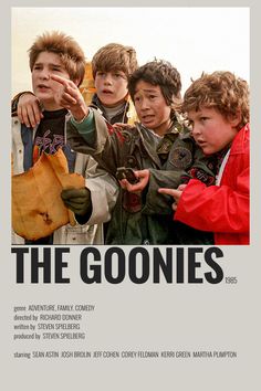 the goonies movie poster with four boys pointing at something in front of their faces