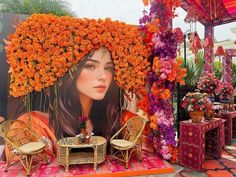 an outdoor area decorated with flowers and wicker chairs