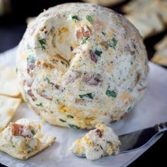 a cheese ball and crackers on a napkin