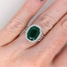 This beautiful ring features a 5.6 carat cushion cut Emerald gemstone with natural earth mined diamonds set in solid 14K gold. This ring makes a lovely May birthstone gift for your loved ones! This ring is made with solid 14K Gold and natural Earth mined SI / G-H diamonds. As listed, this ring is ready to ship. If you're interested in purchasing this setting with a different center stone please message us! Designer Silver Jewellery, Gold Cushions, Cushion Cut Ring, Gold Cocktail Ring, Jewelry Showcases, Gold Cocktail, May Birthstone, Birthstone Gifts, Emerald Gemstone