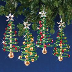 three christmas tree ornaments hanging from a fir tree with red, green and gold beads