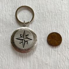 Please note: If you need more than one, multiple quantities are available upon checkout. A silver compass locket key chain--a great twist on the traditional locket and perfect for people who do not want a locket necklace. This makes a sentimental unisex gift--suitable for men and women. A unique gift for groomsmen, fathers, brothers--anyone that wants to carry a memento from a special event or favorite photographs. The silver plated brass locket is a 32mm and opens for a secret place to keep pic Personalized Silver Keychain For Personal Use, Personalized Silver Keychain, Personalized Silver Keychain Gift, Silver Keychain With Key Clip As Gift, Silver Keychain With Key Clip For Gift, Mens Locket, Locket For Men, Compass Locket, Rose Locket