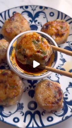 some food is sitting on a plate with chopsticks in the bowl and sauce