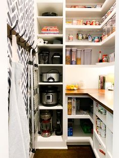 an organized pantry with white shelving and shelves