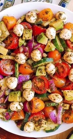 a white plate topped with lots of veggies