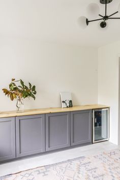 a plant is sitting on top of a gray cabinet