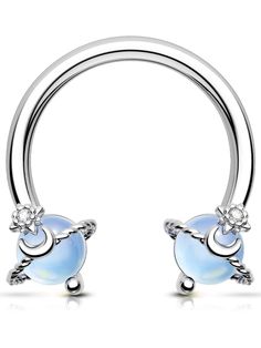 a pair of silver nose rings with blue opal and crystal stones on each end