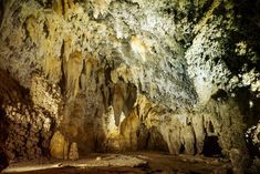 the inside of a cave with lots of rock formations