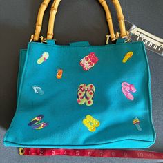 Tianni Turquoise, Embroidered Bamboo Handle Purse. Brand New With Tags In Excellent Condition. Casual Blue Embroidered Bag, Blue Summer Bags For The Pool, Blue Summer Pool Bags, Blue Embroidered Beach Bag, Blue Embroidered Vacation Bag, Blue Embroidered Beach Bags, Blue Embroidered Bags For Beach, Embroidered Blue Beach Bags, Turquoise Purse