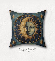 a decorative pillow with an image of the sun and moon on it's side