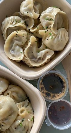 two bowls filled with dumplings on top of a table