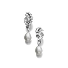 Pair of natural pearl and diamond ear clips, Boucheron, circa 1950 Each set with a drop shaped natural pearl measuring approximately 11.00 x 11.30 x 12.80mm and 10.80 x 11.20 x 13.55mm, suspended from a surmount of brilliant-cut and baguette diamonds, each signed Boucheron, numbered, French assay marks. Luxury Pear-shaped Pearl Drop Diamond Earrings, Luxury White Pear-shaped Pearl Earrings, Boucheron Earrings, Luxury Pear-shaped Exquisite Pearl Earrings, Luxury Pearl Earrings With Diamond Accents, Round Cut, Fine Pearl Jewelry, Ear Clips, Mid Century Jewelry, International Jewelry