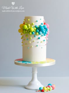 a white cake with multi colored sprinkles on the top and bottom layer